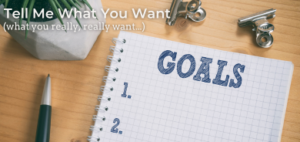 Tell me what you want, with a picture of a notepad and the word 'goals'